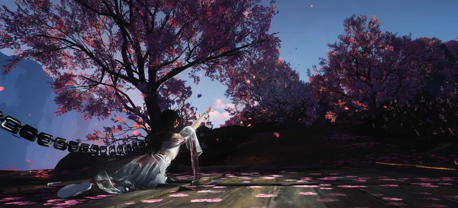 Figure reaching from a low pose beneath pink-blossomed trees.